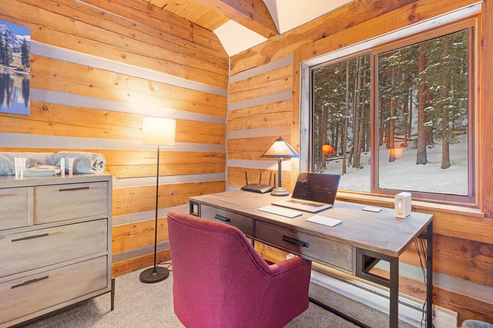 Dedicated workspace: A comfortable work area is located in the main level master bedroom, complete with a desk and chair, ideal for remote work or study.
