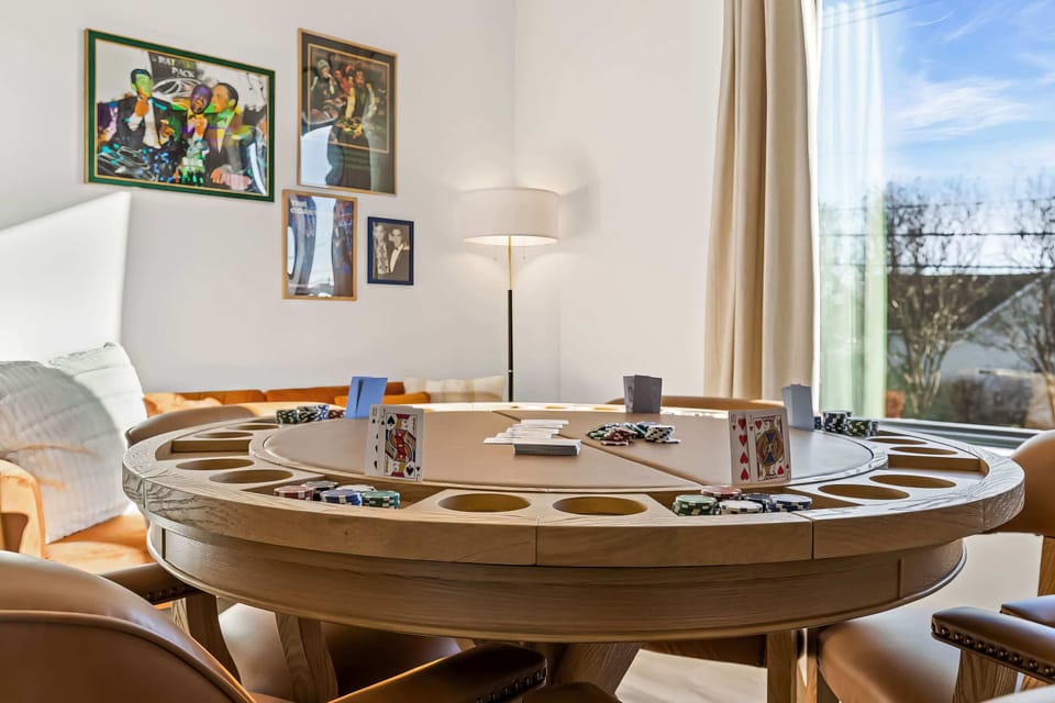 Gather your crew for a stylish getaway in this game room featuring a premium poker table for late-night fun. Perfect for bachelorette parties or family reunions, it's an elegant retreat in Nashville where unforgettable memories await!