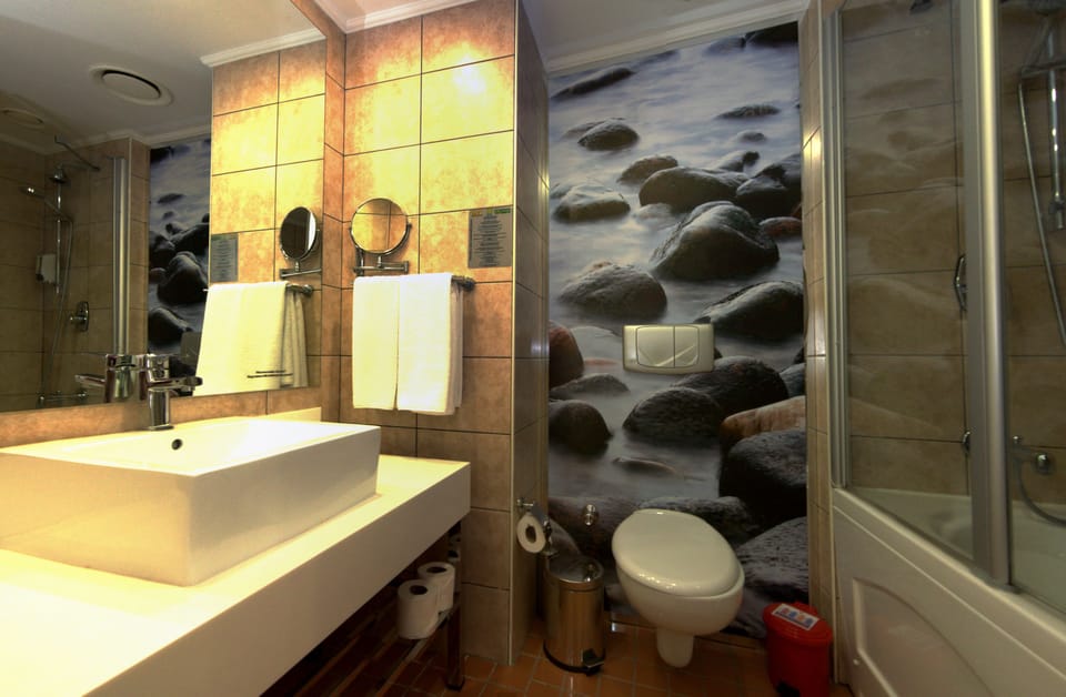Bathtub, eco-friendly toiletries, hair dryer, towels