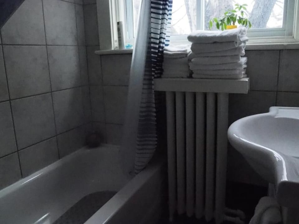 Combined shower/tub, free toiletries, hair dryer, slippers