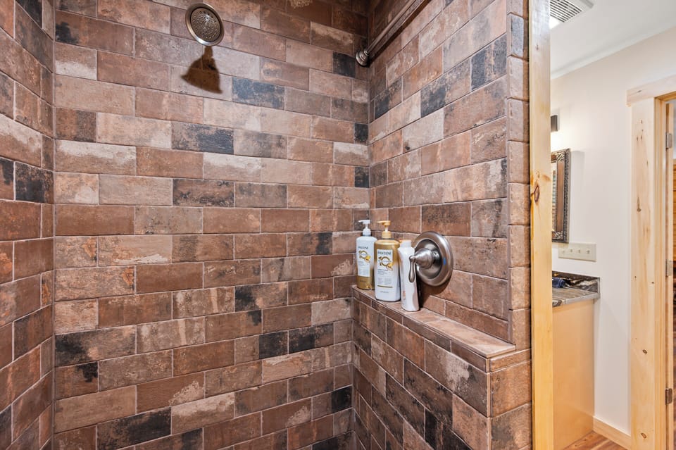 Gorgeous tile in subway pattern set off this statement private shower.