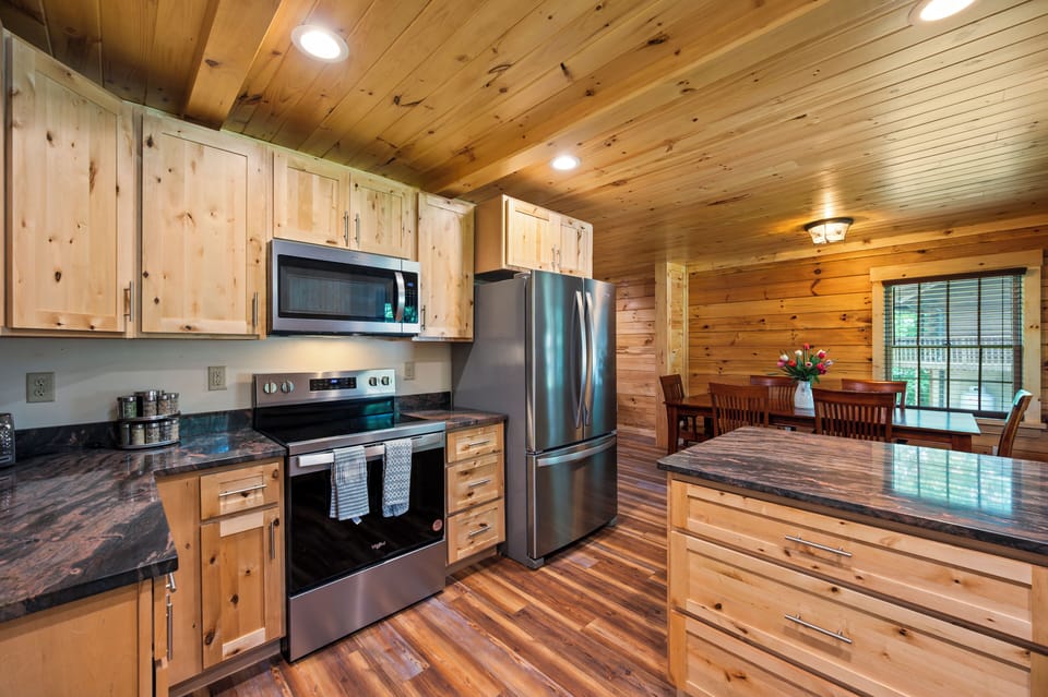 Huge one of a kind natural stone bar overlooks the kitchen, dining and living room are all open for your group to enjoy each others company.