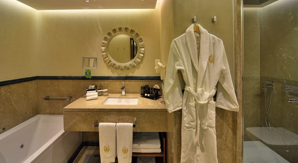 Designer toiletries, hair dryer, slippers, towels