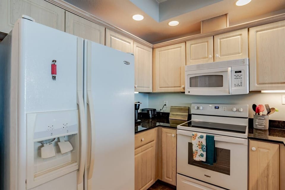 Kichen with side by side fridge, range, microwave, dishwasher, pots, pans, silverware, blender, mixer, coffee pot, toaster everything you need to prepare meals is there for you to use