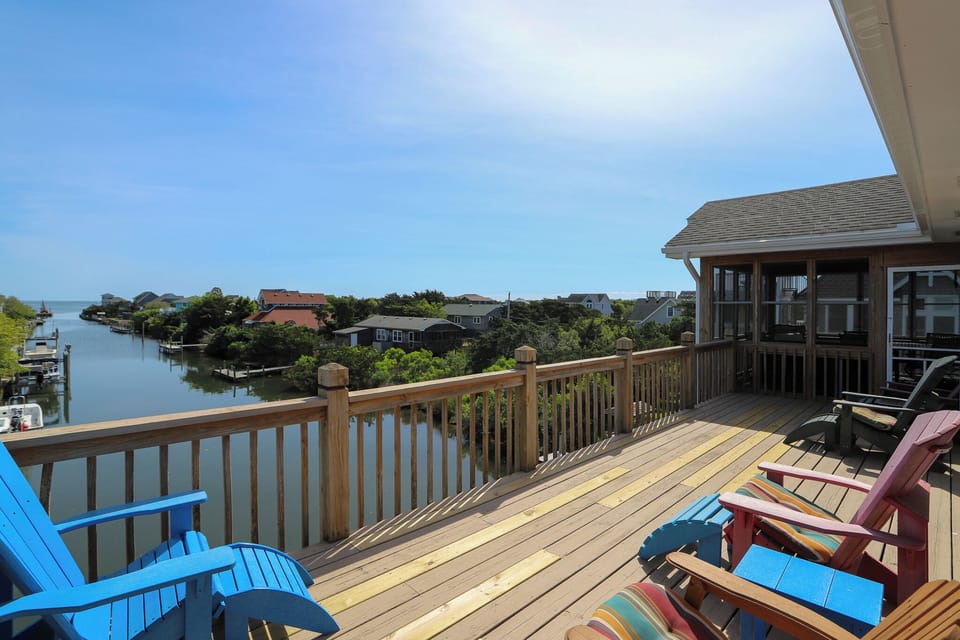 Unwind on your private deck with stunning water views, colorful Adirondack chairs perfect for morning coffee or sunset cocktails.
