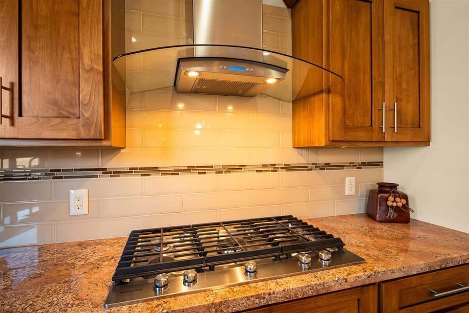 Custom wood cabinetry, double ovens, and large island to entertain
