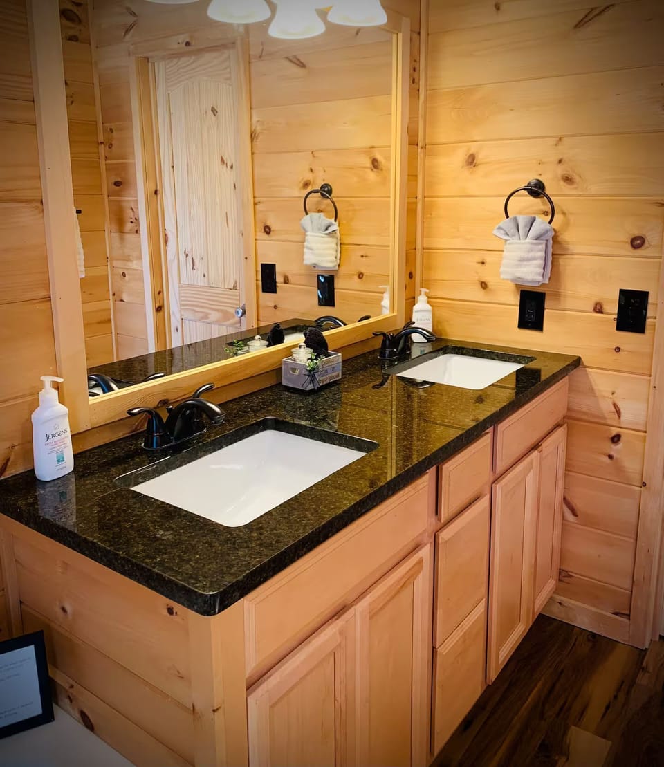 Spacious bathroom with dual sinks, rustic wood touches, and plenty of room to freshen up after a Smoky Mountain day.