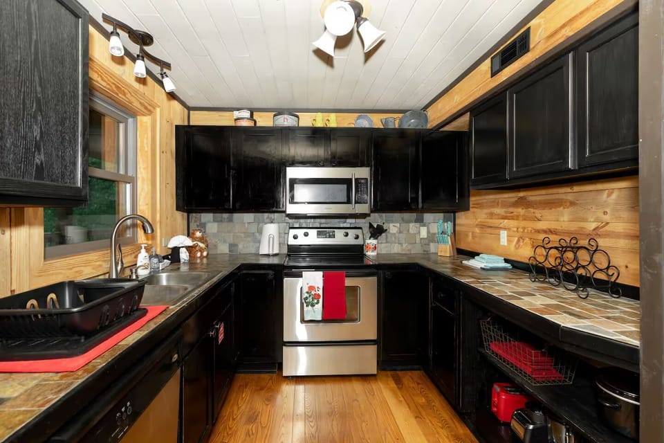 Stylish kitchen awaits, equipped for culinary adventures amidst rustic charm!