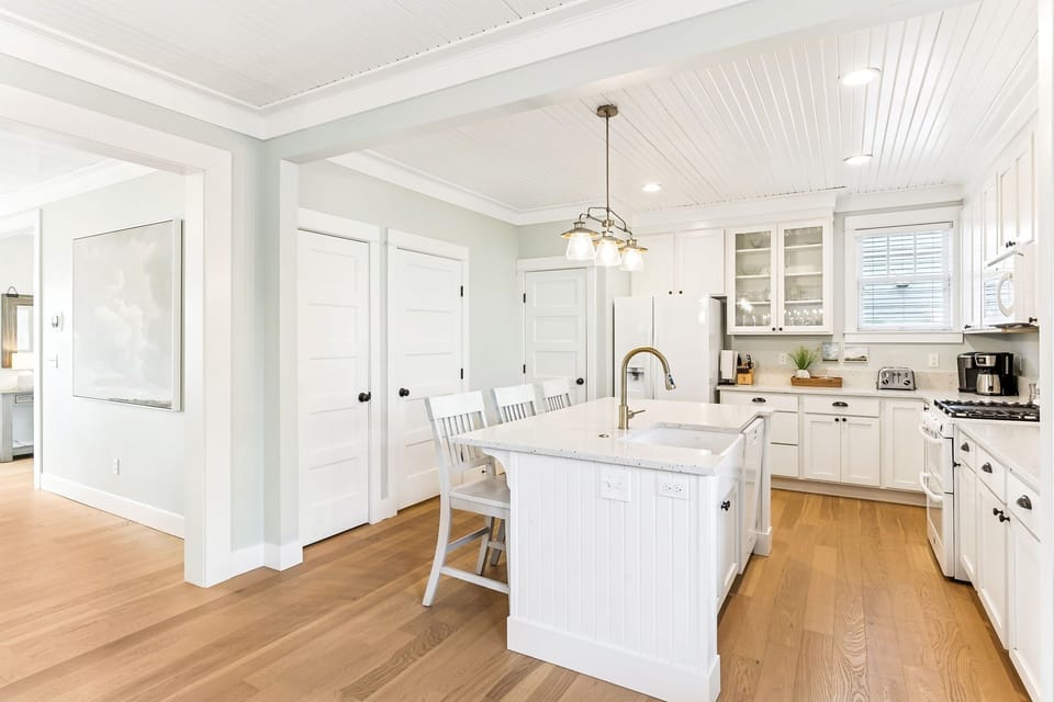 Kitchen provides access to laundry room and half bath