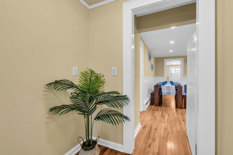 Step into a warm, welcoming entryway that leads to a beautifully set dining space, perfect for gathering with family or friends.