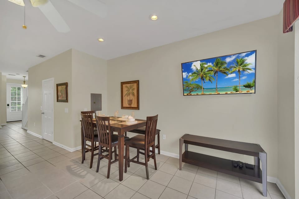 Bright and Airy Dining Area with Modern Touches and Wall-Mounted TV