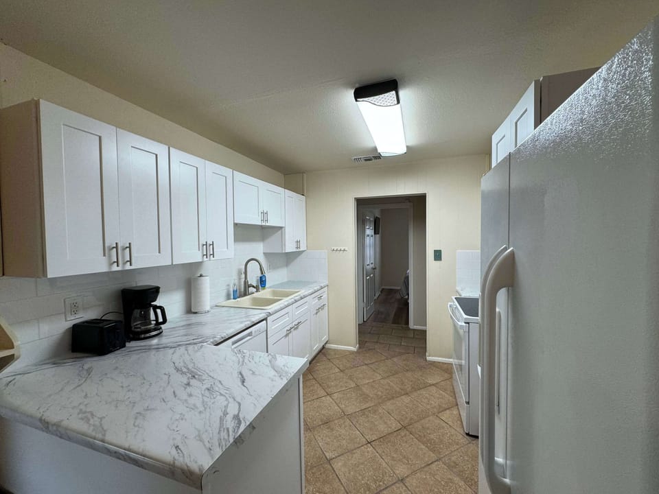 The airy kitchen offers ample space & every home comfort
