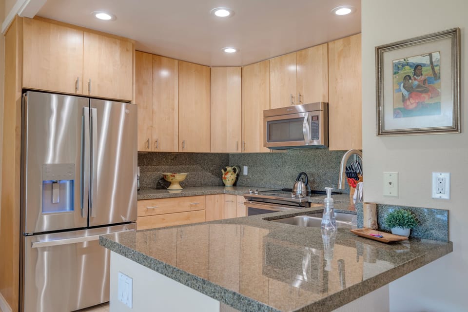 The fully equipped kitchen offers stainless steel appliances, granite counters, and everything you need to dine in.