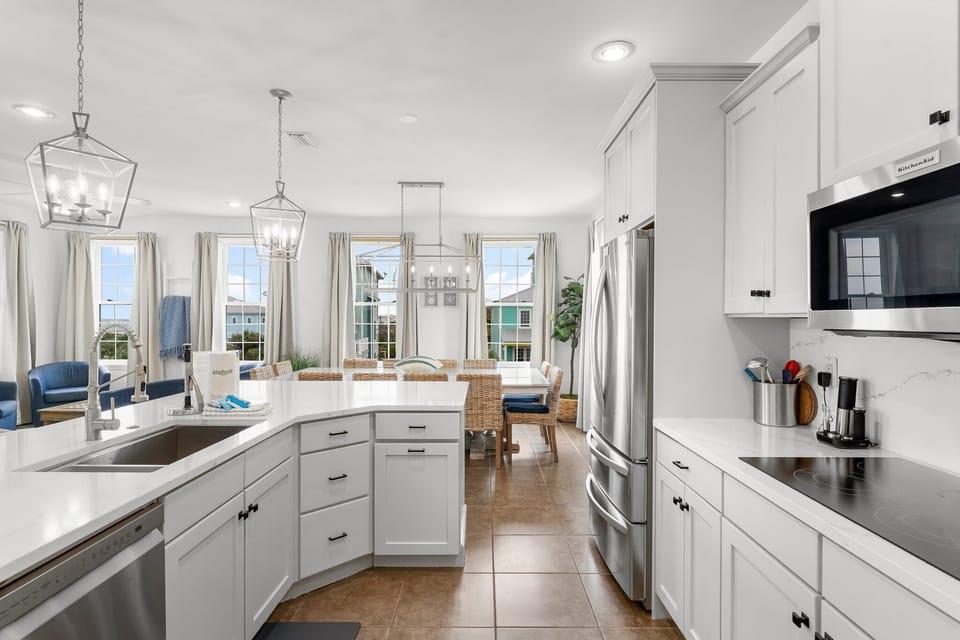 Your spacious kitchen flows seamlessly into the dining area, where natural light streams through large windows as you prepare meals.