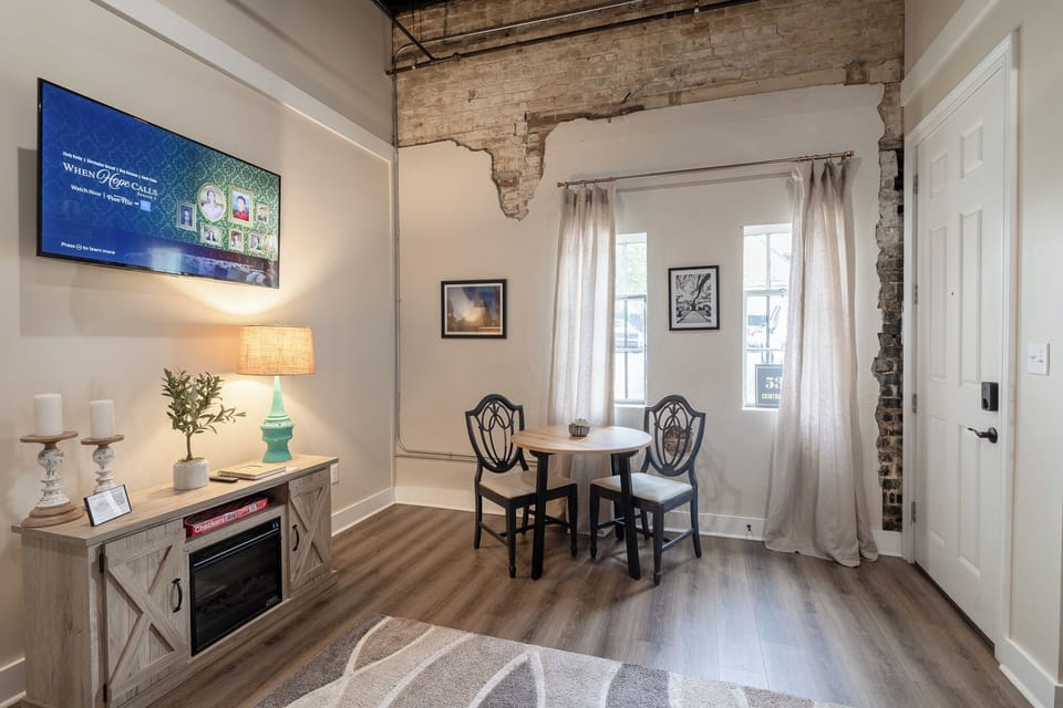 Cozy living space with natural light & a charming window nook — ideal for sipping coffee, journaling, or planning your Home Town adventures in Downtown Laurel. 