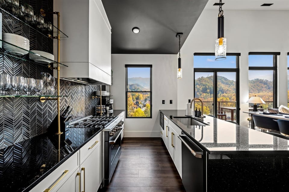 Cook with ease in this wide, fully equipped kitchen featuring stainless steel appliances, granite countertops, and plenty of room for everyone to gather while meals are prepared. Perfect for family feasts or casual snacks!