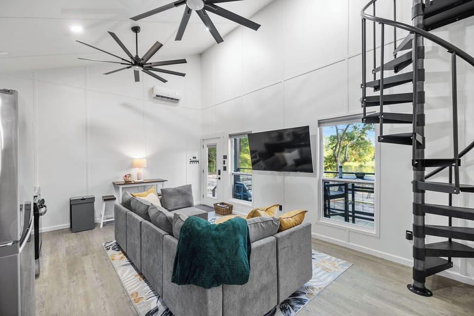 Living Room w/ spiral staircase to loft