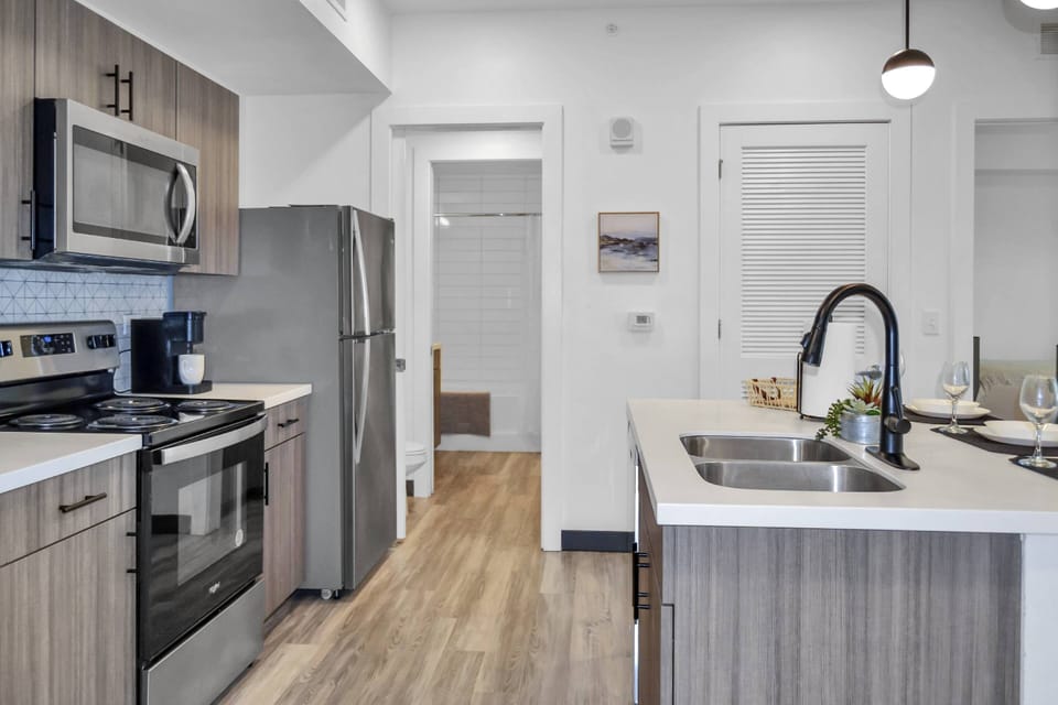 Kitchen area with all stainless steel appliances - microwave, Keurig pod coffee maker, dishwasher, range & refrigerator!