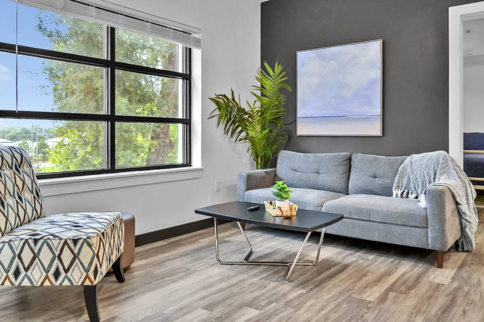 Living room with comfortable couch & accent chair seating & 50" Smart TV!