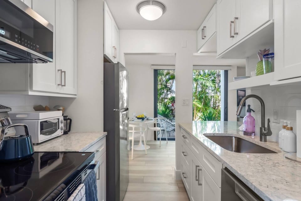 A bright, modern kitchen that brings a light and airy feel to your vacation stay.