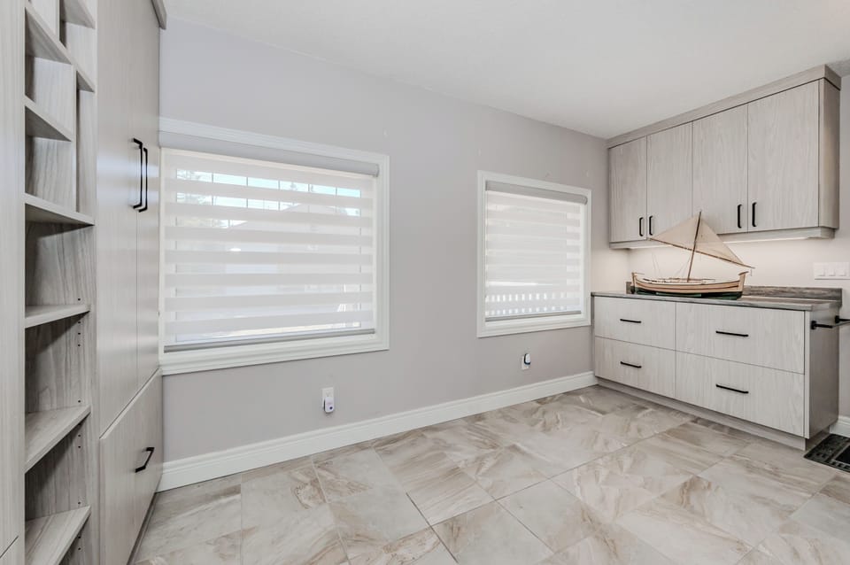 Modern laundry room with ample counter space and cabinetry—perfect for extended vacation stays, family getaways, or lakeside adventures that call for fresh clothes anytime.