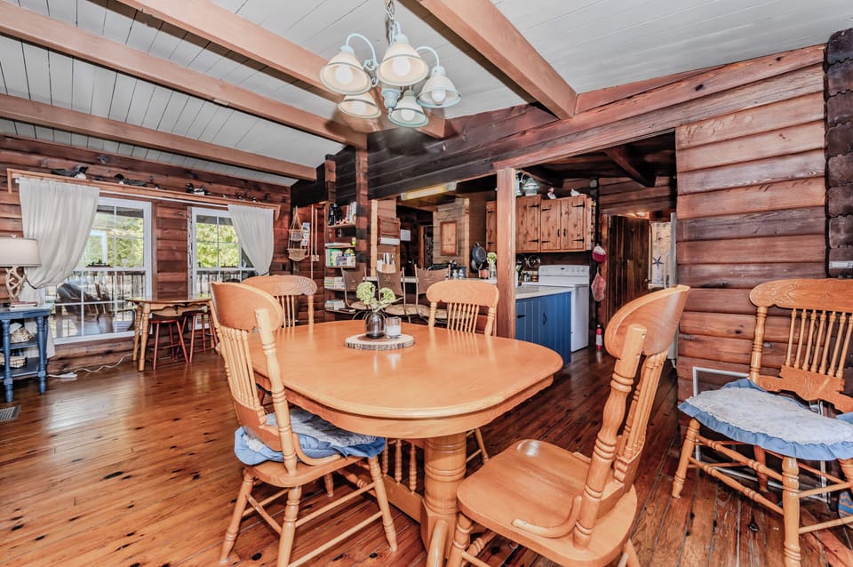 Experience rustic comfort at this log cabin vacation rental featuring a fully equipped kitchen, spacious dining area, and warm wood interiors—ideal for relaxing family holidays, group getaways, or peaceful nature escapes.