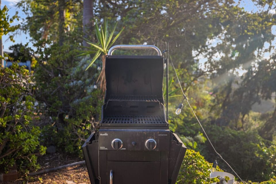 Outdoor grill area surrounded by nature, perfect for enjoying a backyard barbecue.