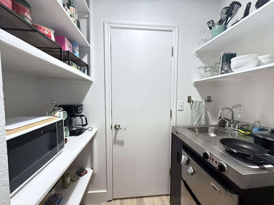 Small but mighty Kitchenette with cooktop, mini fridge, sink, and microwave