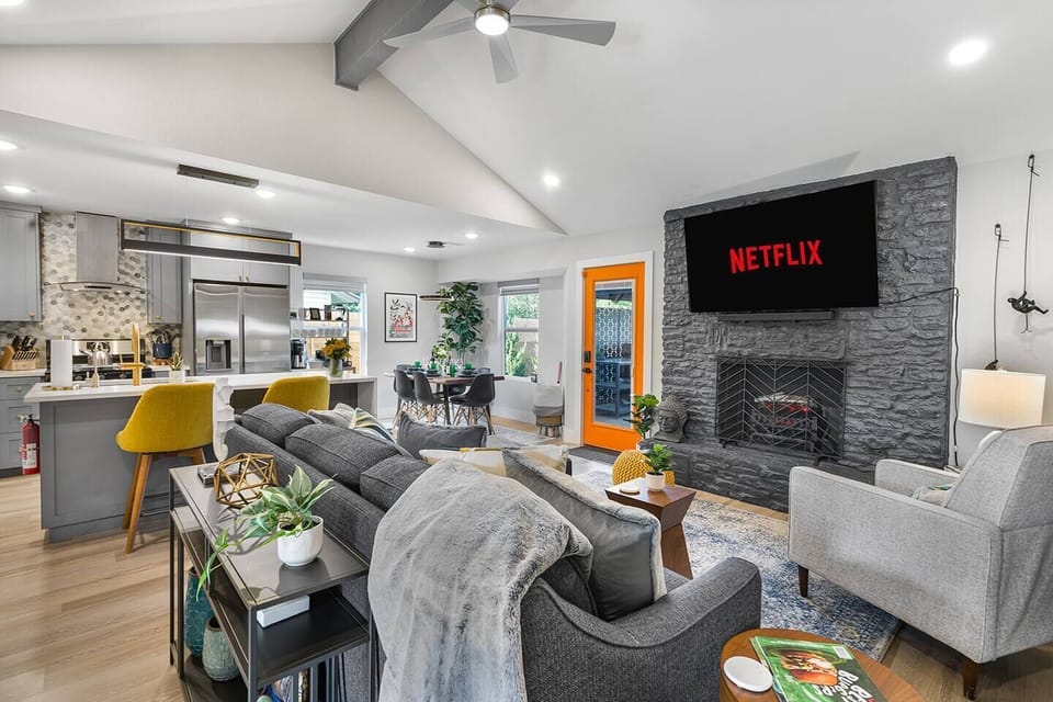 Comfortable living room, faux fireplace, and 65" Roku smart tv.