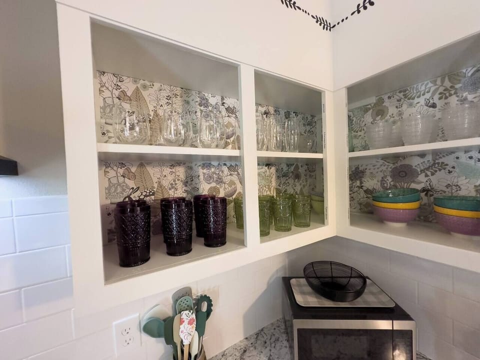 Kitchen open shelving with glassware.