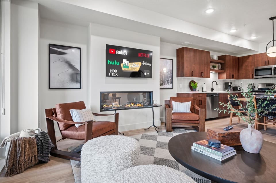 The open-concept living space, complete with a dining area, facilitates effortless conversation with family and friends.