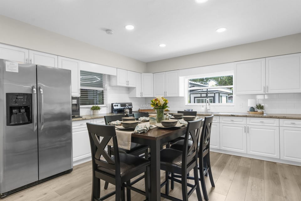 Watch the family play in the pool from the kitchen