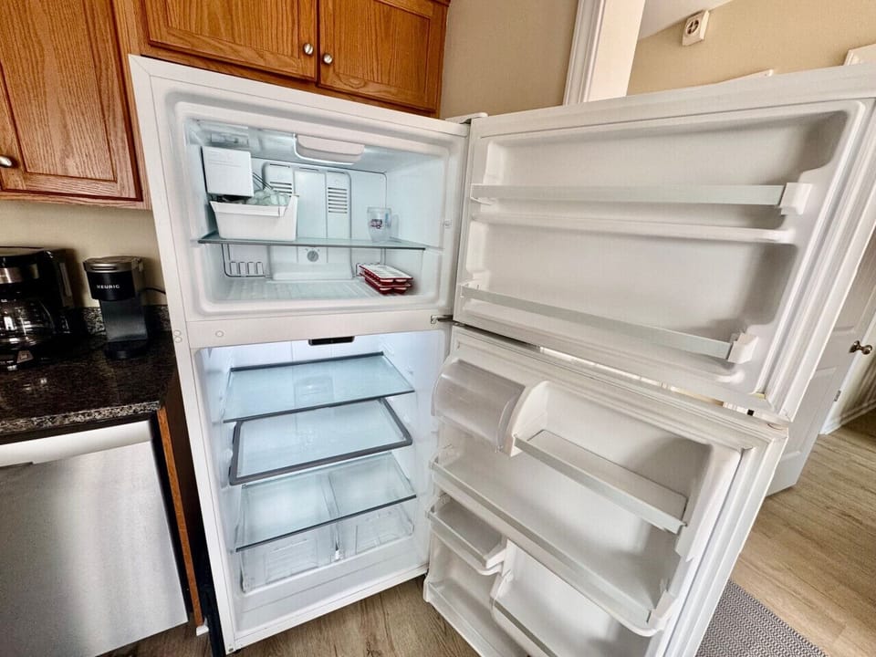 Kitchen with new appliance, ice maker, and sitting area.