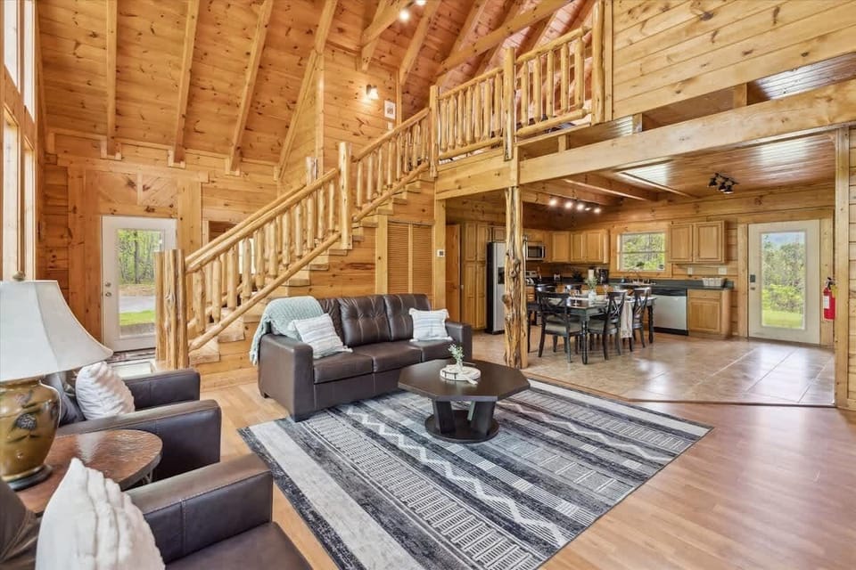 Living Room: Sunlight dances through tall windows, highlighting rustic charm and inviting gatherings!
