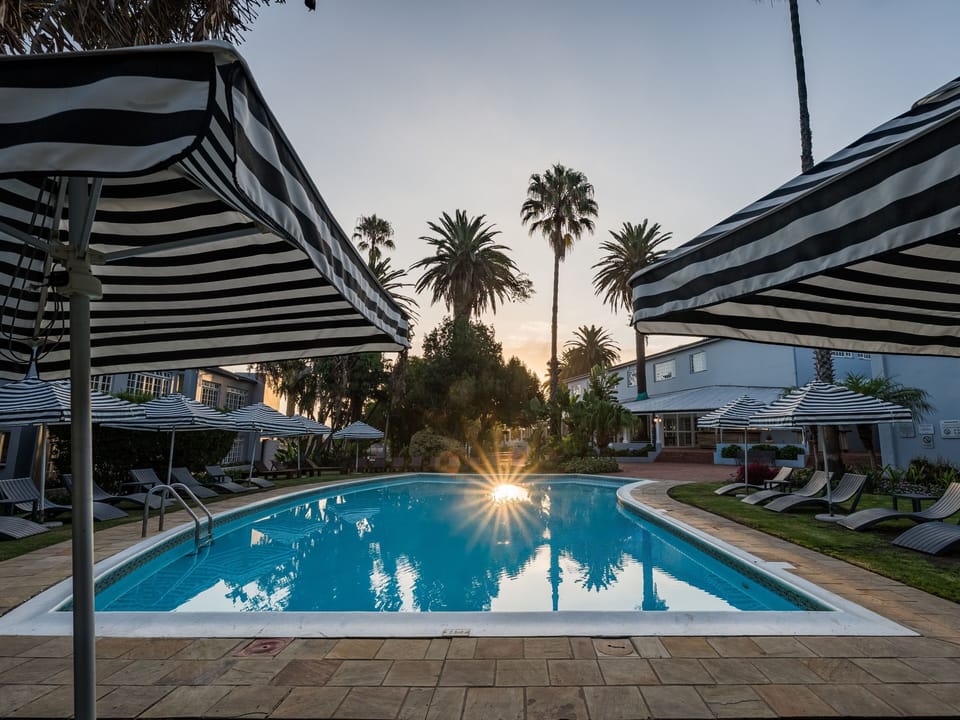 Outdoor pool, open 7:00 AM to 7:00 PM, pool umbrellas, sun loungers