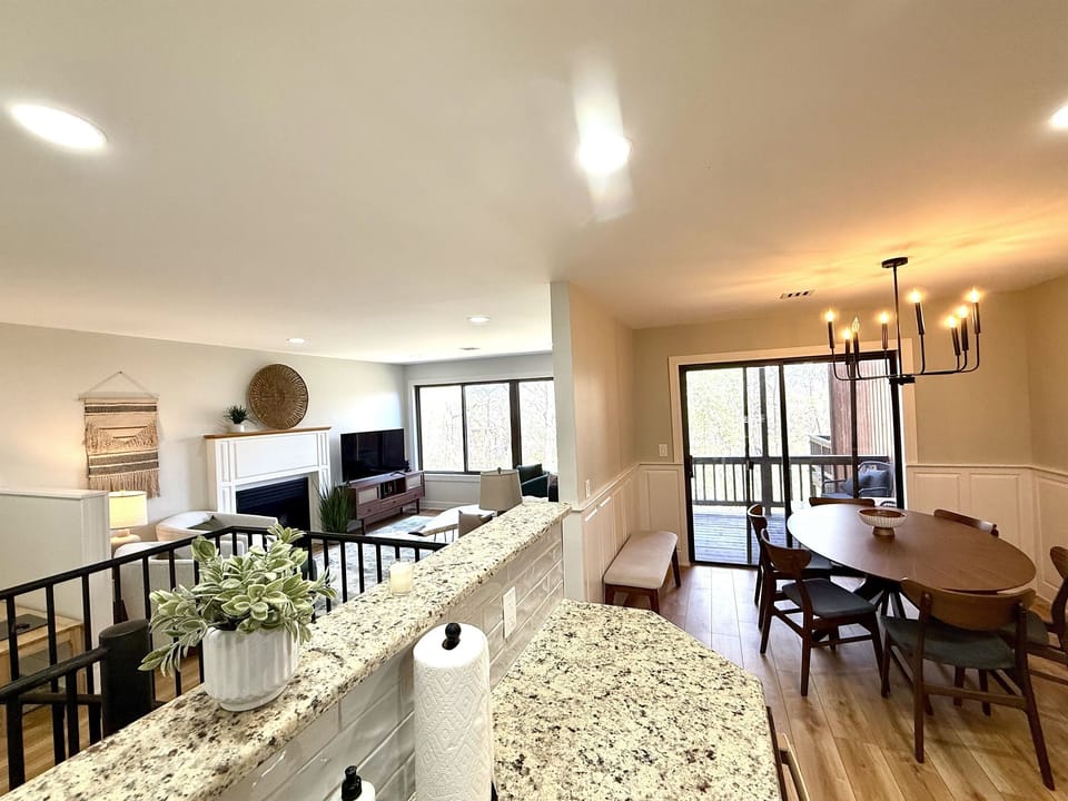 Open-concept living from the kitchen with sweeping treetop views—perfect for gathering, dining, and relaxing in nature.