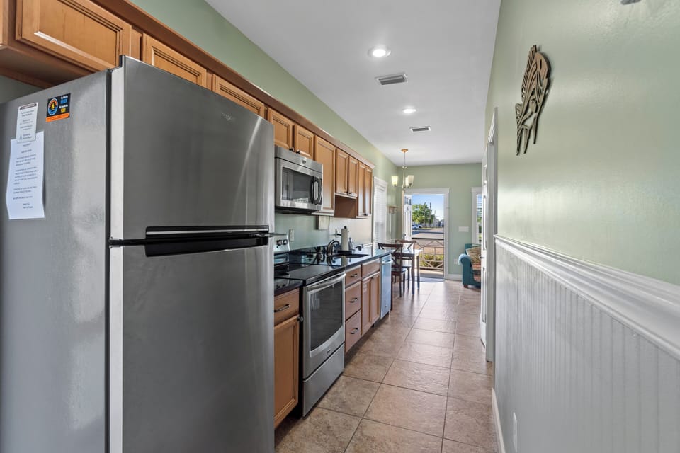 Your fully-equipped kitchen features stainless steel appliances and warm wood cabinets, perfect for preparing meals during your stay.