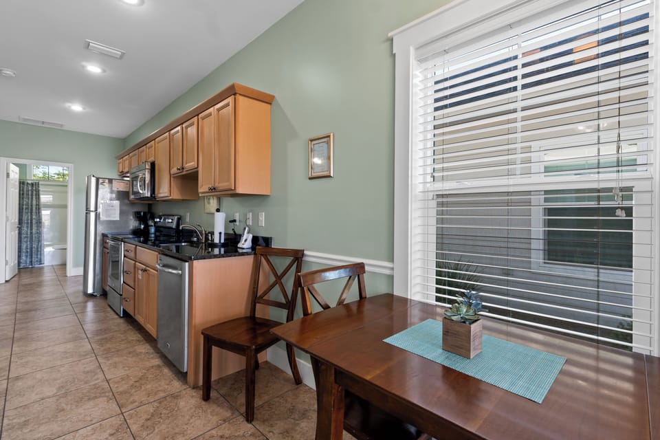Your fully equipped kitchen features warm wood cabinets, granite counters, and a cozy dining nook where you can savor morning coffee.