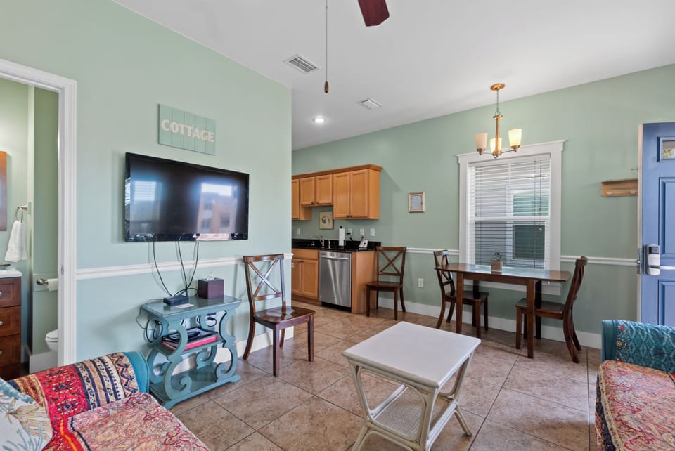 Your charming cottage features an open layout where you can cook, dine, and relax in one welcoming space with soothing colors and comfortable furnishings.