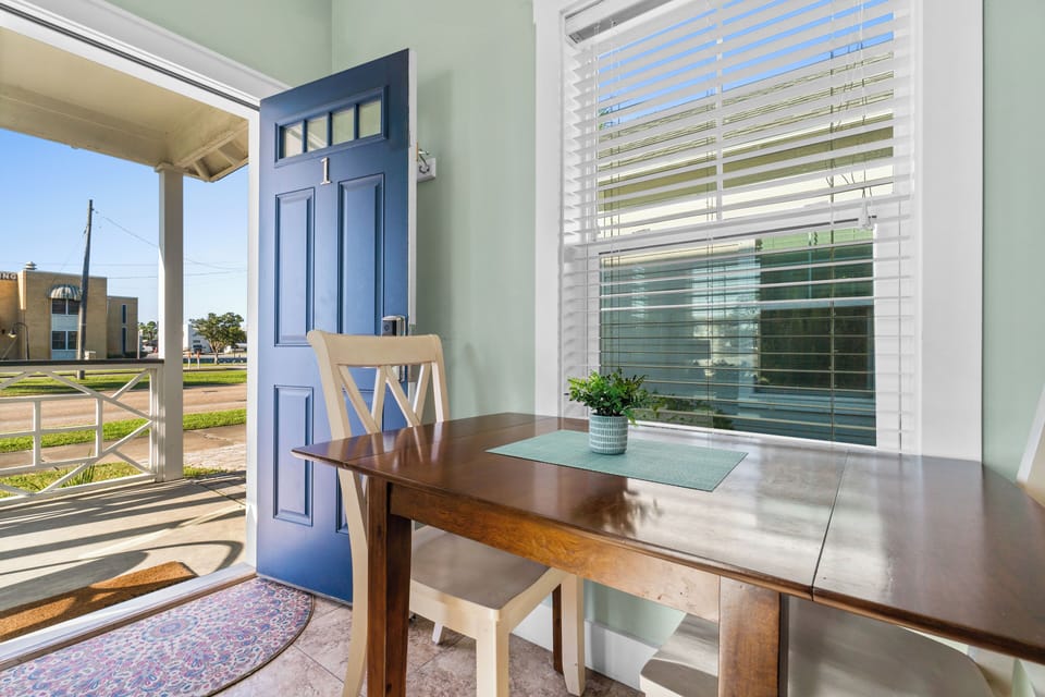 Settle into your peaceful dining nook with morning coffee, where soft mint walls and natural light create the perfect workspace.