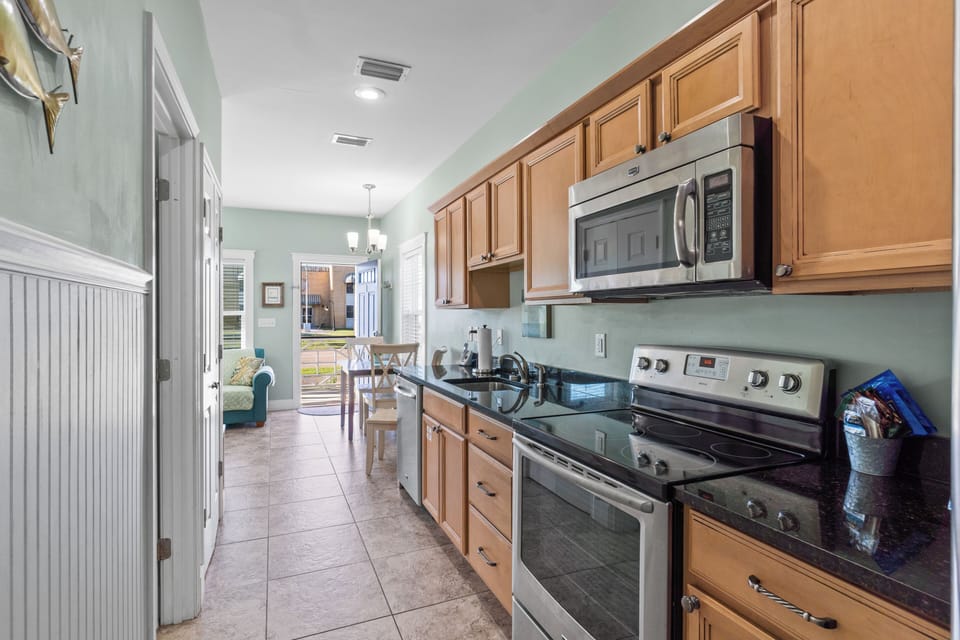 Your fully equipped galley kitchen features granite counters, stainless appliances, and everything you need to create memorable meals together.