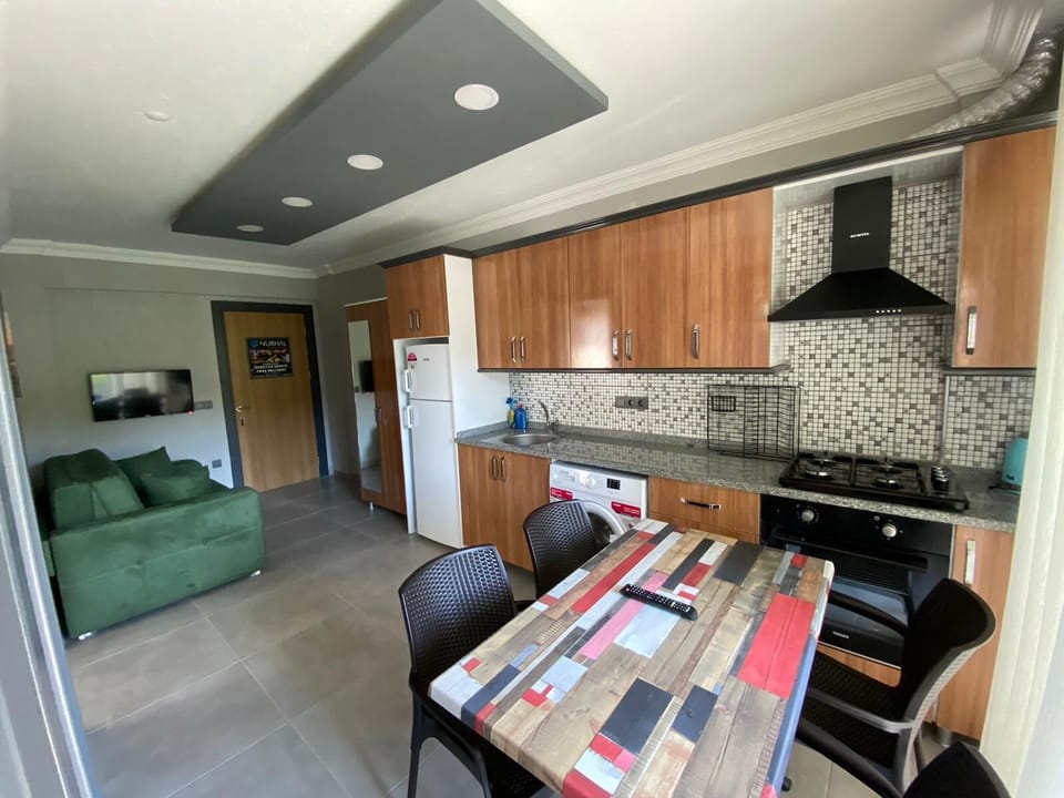 Deluxe Apartment, Balcony, Pool View | Private kitchen | Full-size fridge, microwave, oven, stovetop