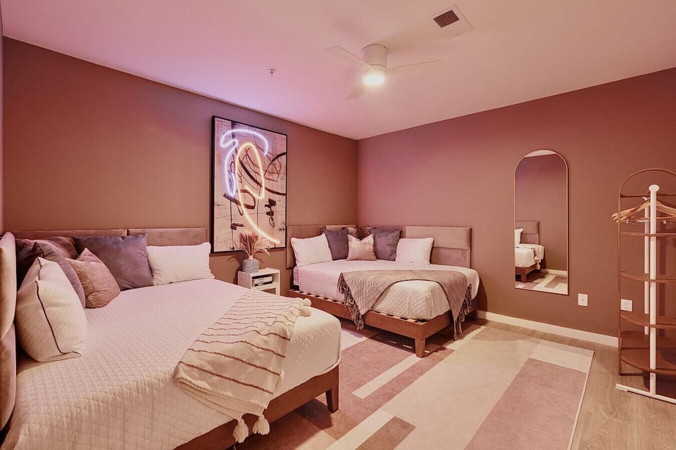 Bedroom 4: 2 Queen size bed with a warm, earthy color palette, plush bedding, and a striking abstract artworkBedroom 4: 2 Queen size bed with a warm, earthy color palette, plush bedding, and a striking abstract artworkBedroom 4: 2 Queen size bed with a wa