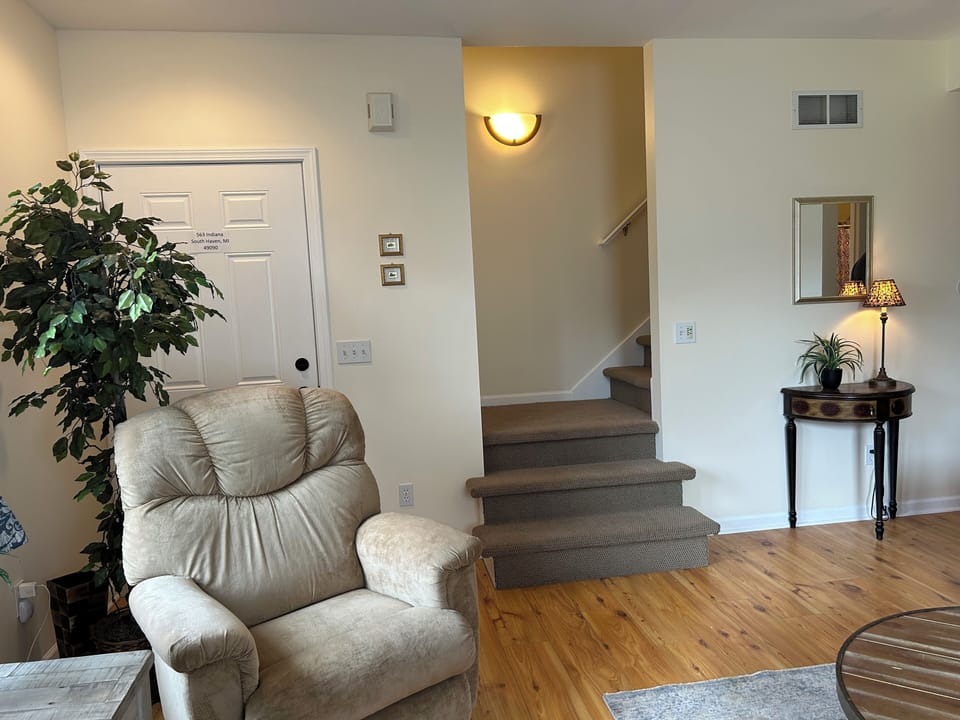 Living Room showing front entrance and stairs to upper level
