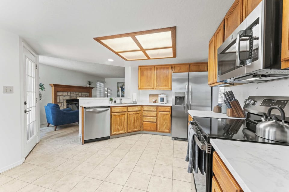 Cook and connect in this open, well-appointed kitchen featuring stainless steel appliances, generous counter space, and plenty of cabinetry