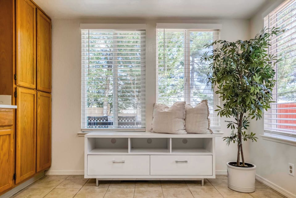 A bright and welcoming nook with large windows, built-in bench seating, and cozy cushions—perfect for morning coffee, reading, or simply enjoying the natural light. A charming little retreat within the home