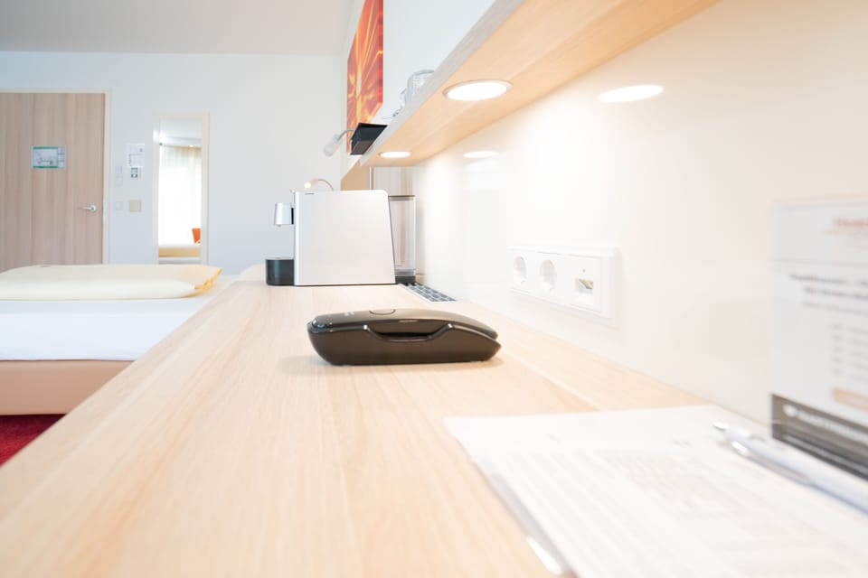 Comfort Single Room | Living area | 55-inch flat-screen TV with cable channels, TV, offices