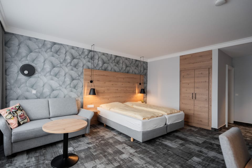 Quadruple Room | Living area | 55-inch flat-screen TV with cable channels, TV, offices
