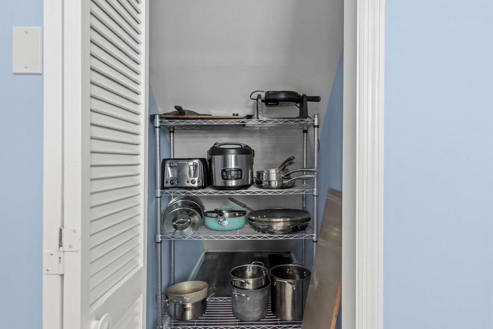 Fully stocked with pans, pots, a rice cooker, and a toaster, ensuring you have everything you need to prepare delicious meals.
