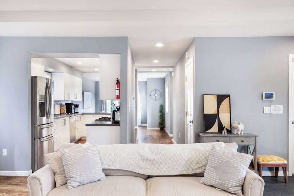 The kitchen’s right behind the sofa—grab a snack mid-movie night or chat with friends while you prep. Even the corner shelf has a few cozy touches.